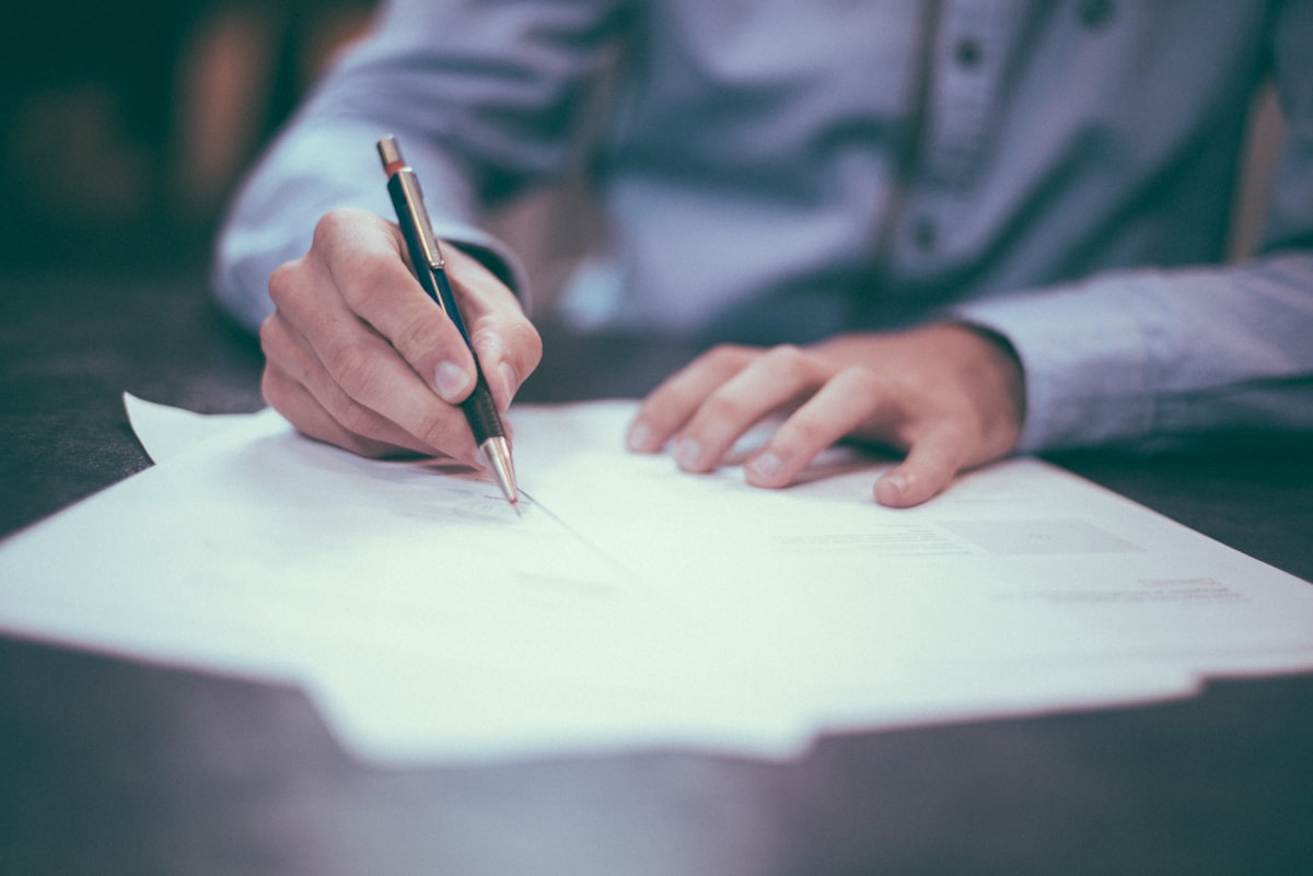 Hands reviewing and signing a commercial contract
